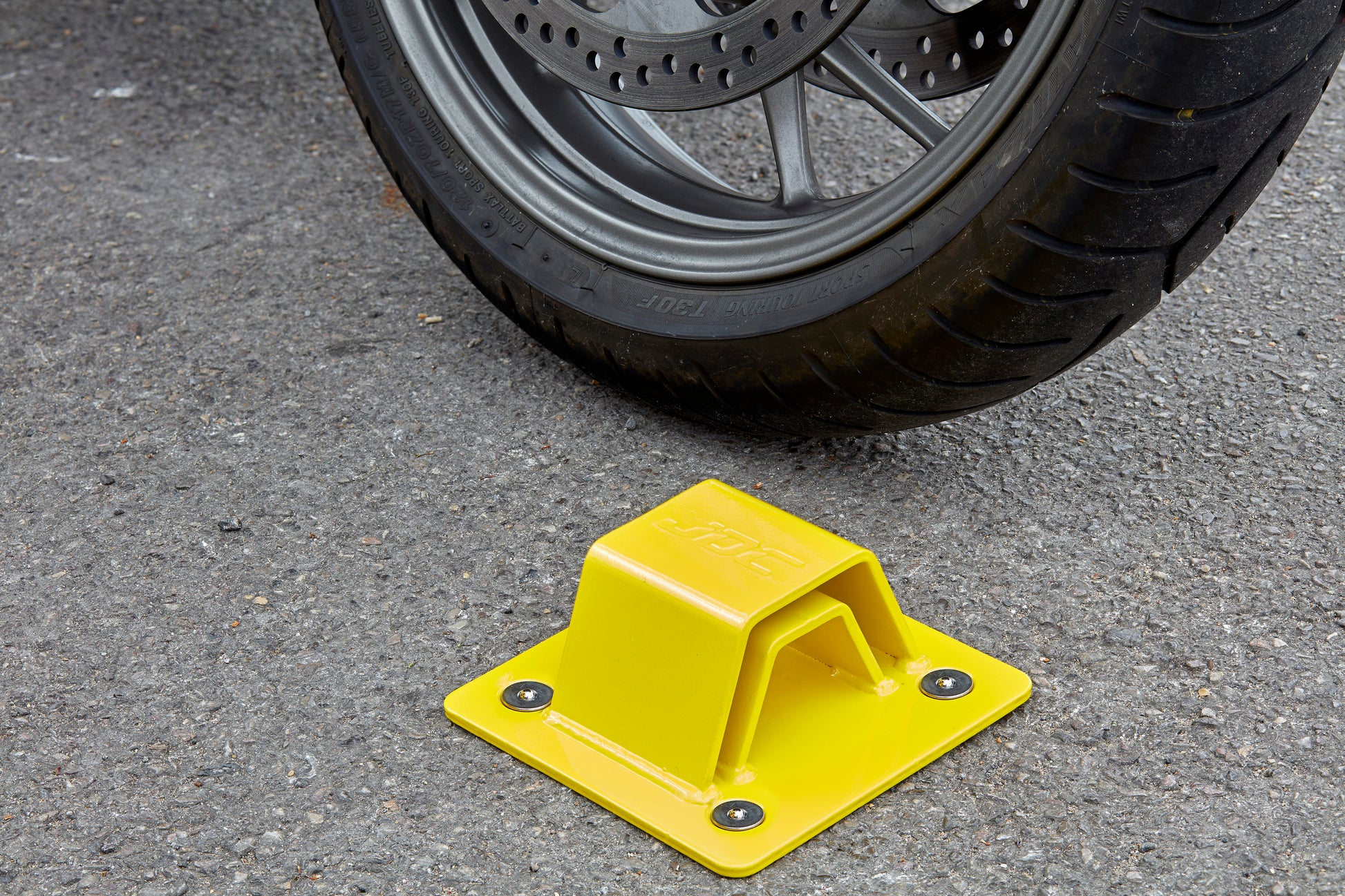 JDC Product's Sphere Pro Ground Anchor shown with motorbike