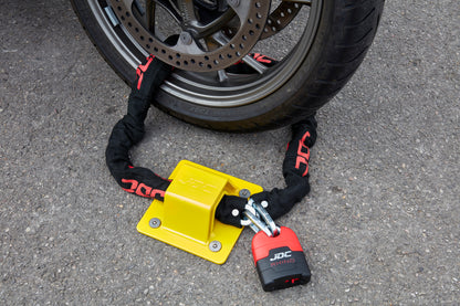 JDC Product's Sphere Pro Ground Anchor shown with JDC Heavy Duty Bike Chain securing a motorbike